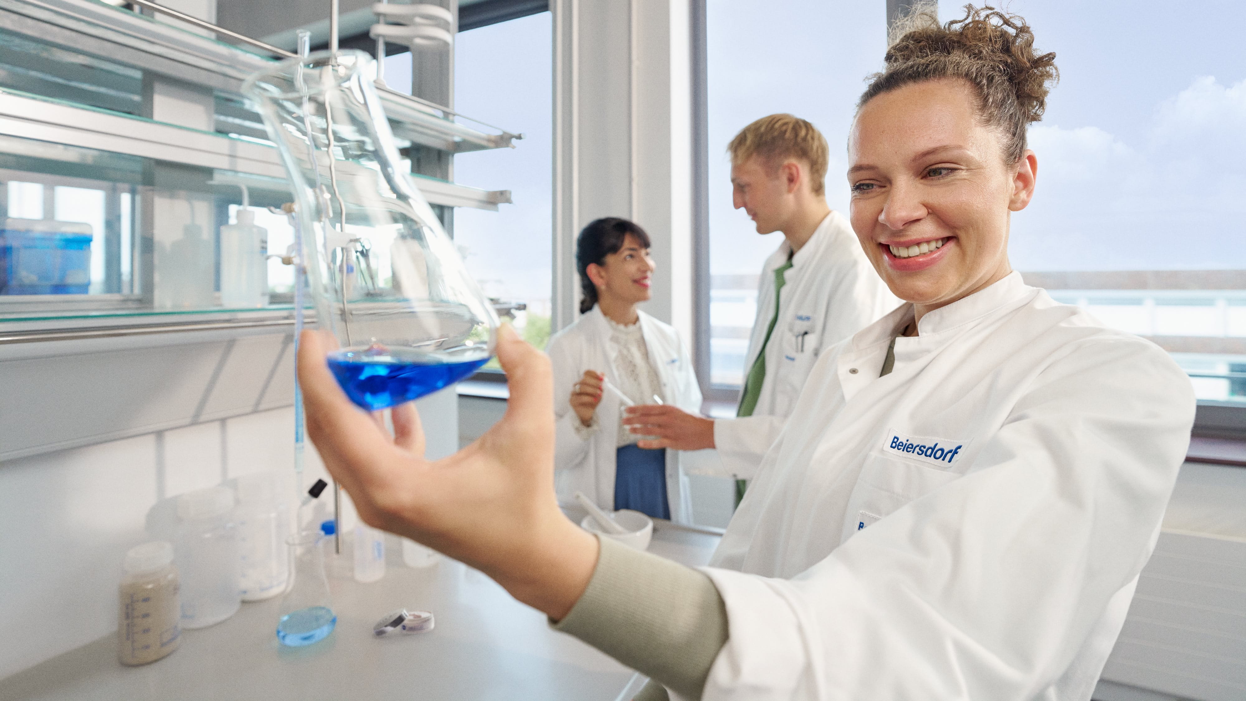 Three colleagues in a lab conducting innovative research.