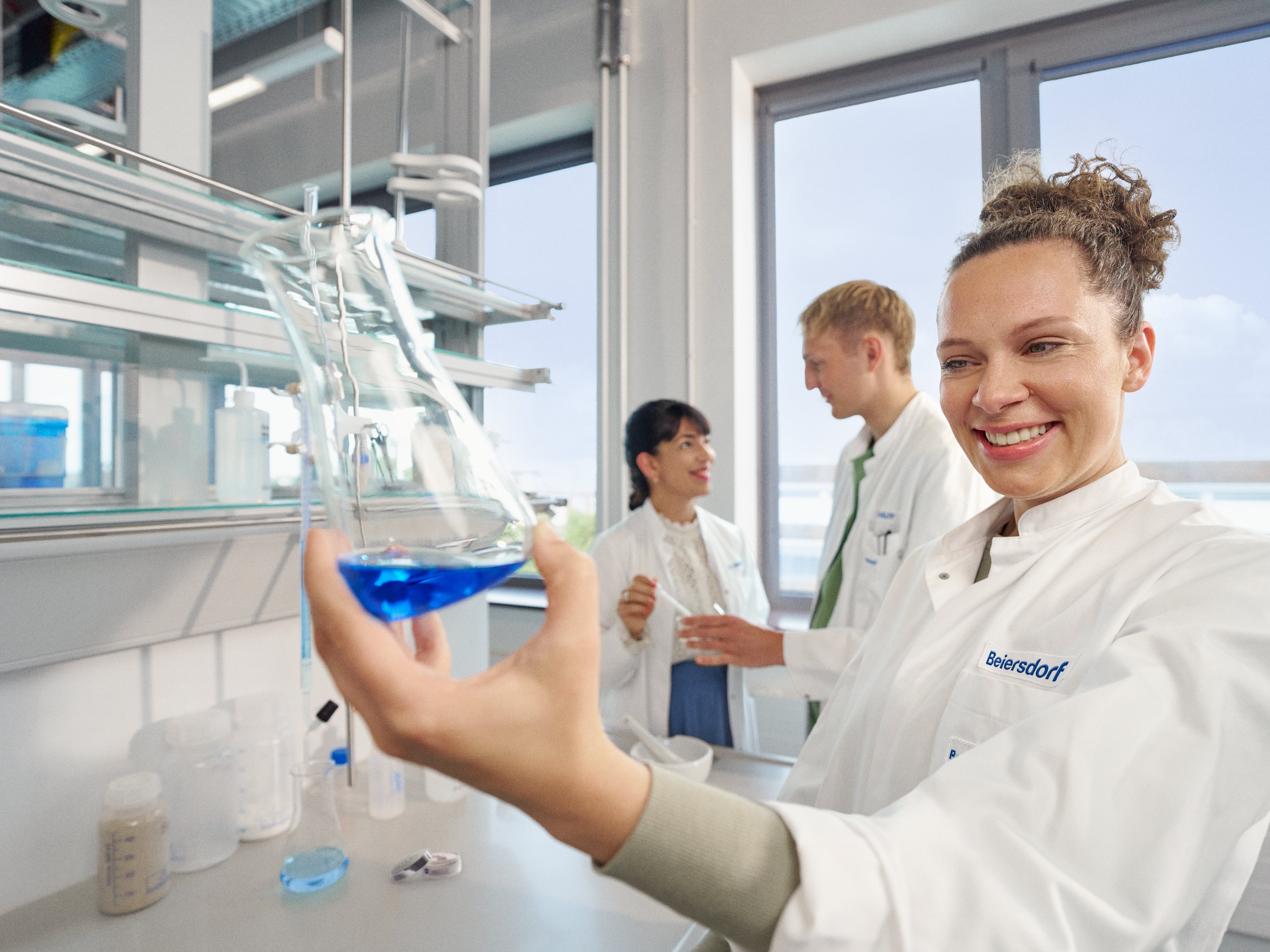 Three colleagues in a lab conducting innovative research.