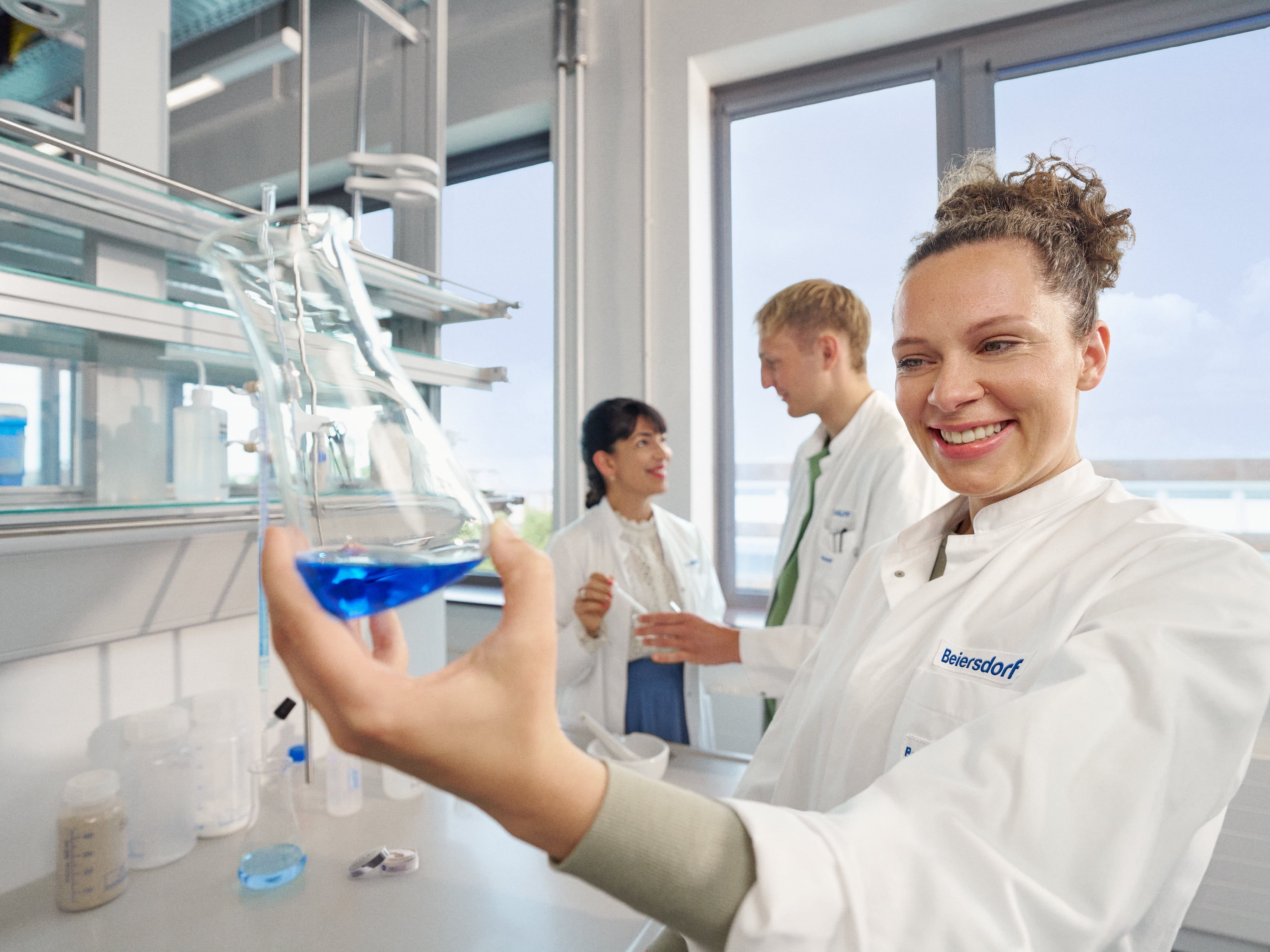 Three colleagues in a lab conducting innovative research.
