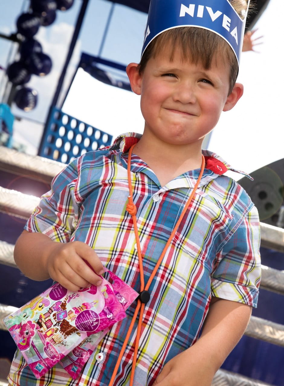 young boy with NIVEA crown and sweets