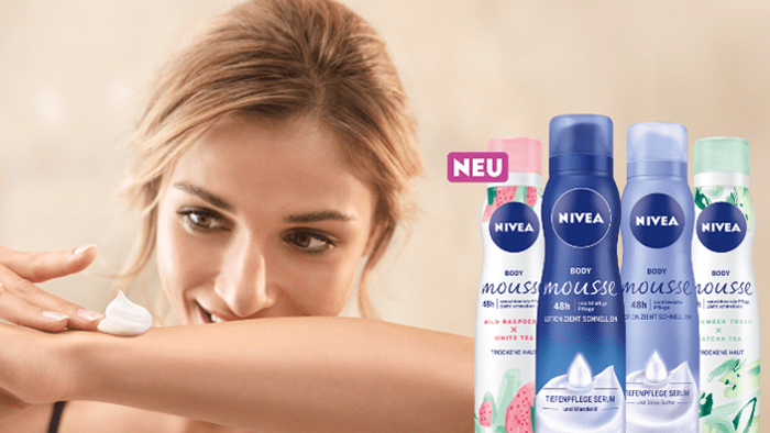 Woman applying NIVEA BODY Mousse