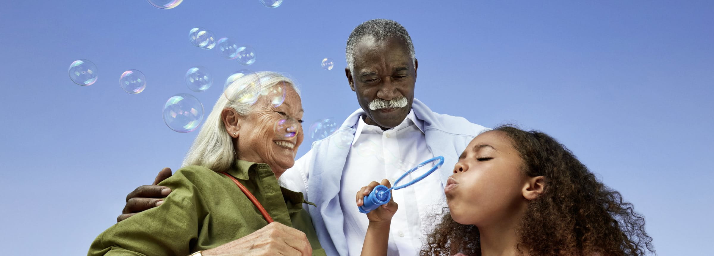 Close-up of hands gently resting together, showing connection and support, with colorful bracelets visible on the wrist.
