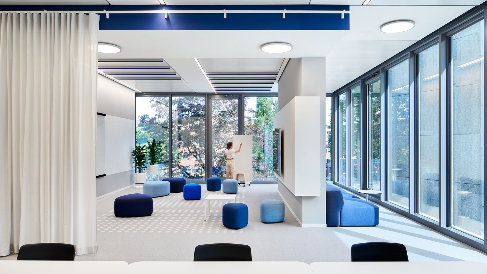 A corporate presentation slide titled "Beiersdorf at a Glance" featuring a dark blue summary bar and a business segment breakdown. The summary bar notes the company was founded in 1882, has 17,398 employees, reached €6,285 million in Group Sales for 2014, and is listed on the DAX. A central donut chart labeled "Business Segments" illustrates the division between the "Consumer" and "tesa" segments. The Consumer quadrant highlights three global brands—NIVEA (+6.2%), Eucerin (+6.0%), and La Prairie (+5.1%)—noting significant market share gains in 2014. The tesa quadrant details strong 2014 development, noting that B2B accounts for 74% of sales across electronics, automotive, print, and paper industries, while B2C contributes 26% through the office and DIY sectors.