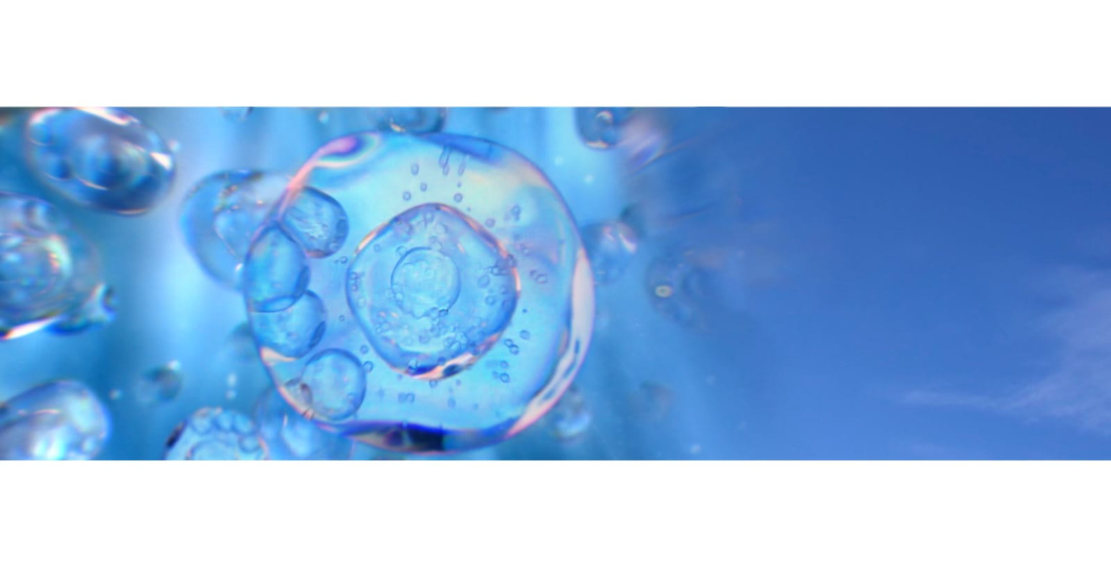 Abstract blue background with translucent bubbles and circular shapes floating in liquid, suggesting hydration or skincare science.