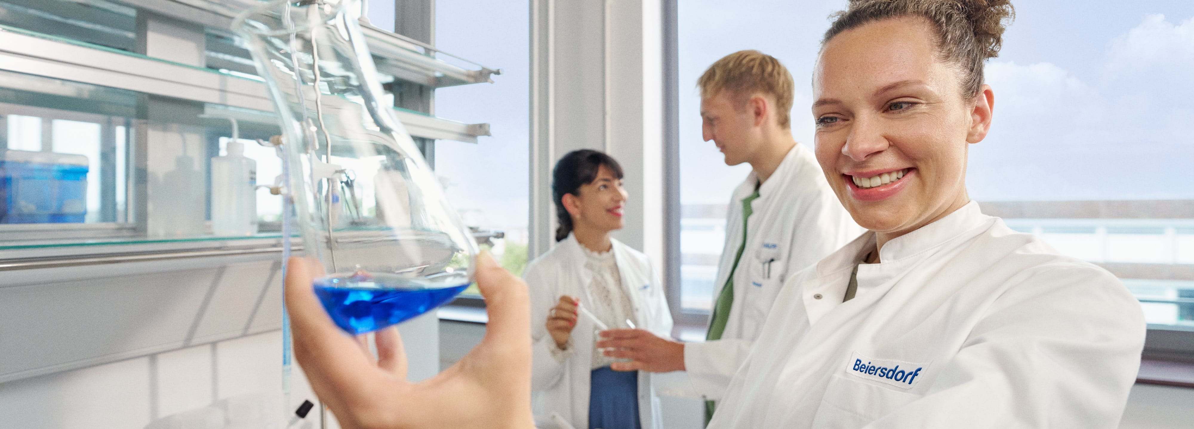 Beiersdorf researchers collaborating in a laboratory, driving innovation and the development of skincare and consumer care solutions.
