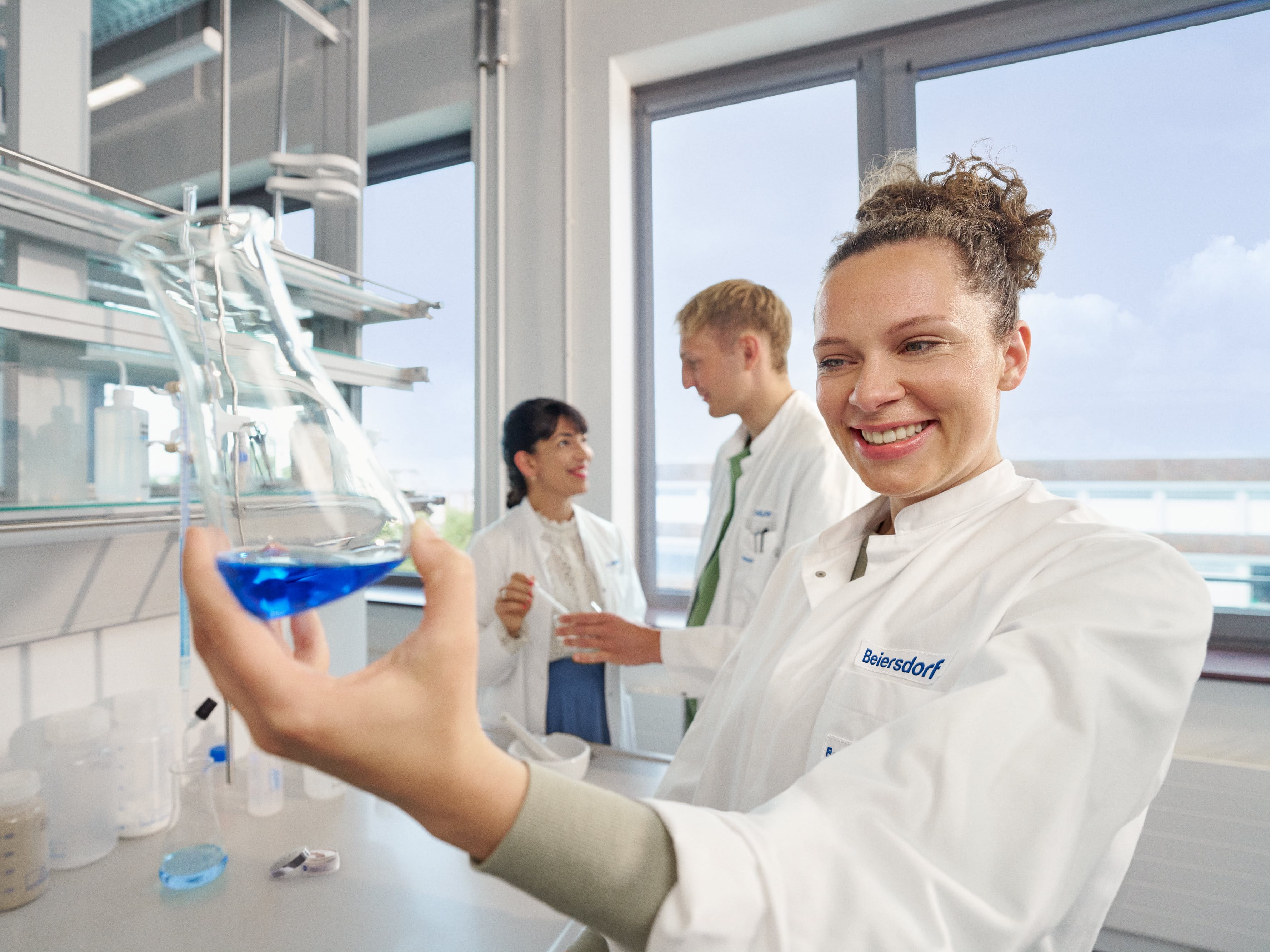 Beiersdorf researchers collaborating in a laboratory, driving innovation and the development of skincare and consumer care solutions.