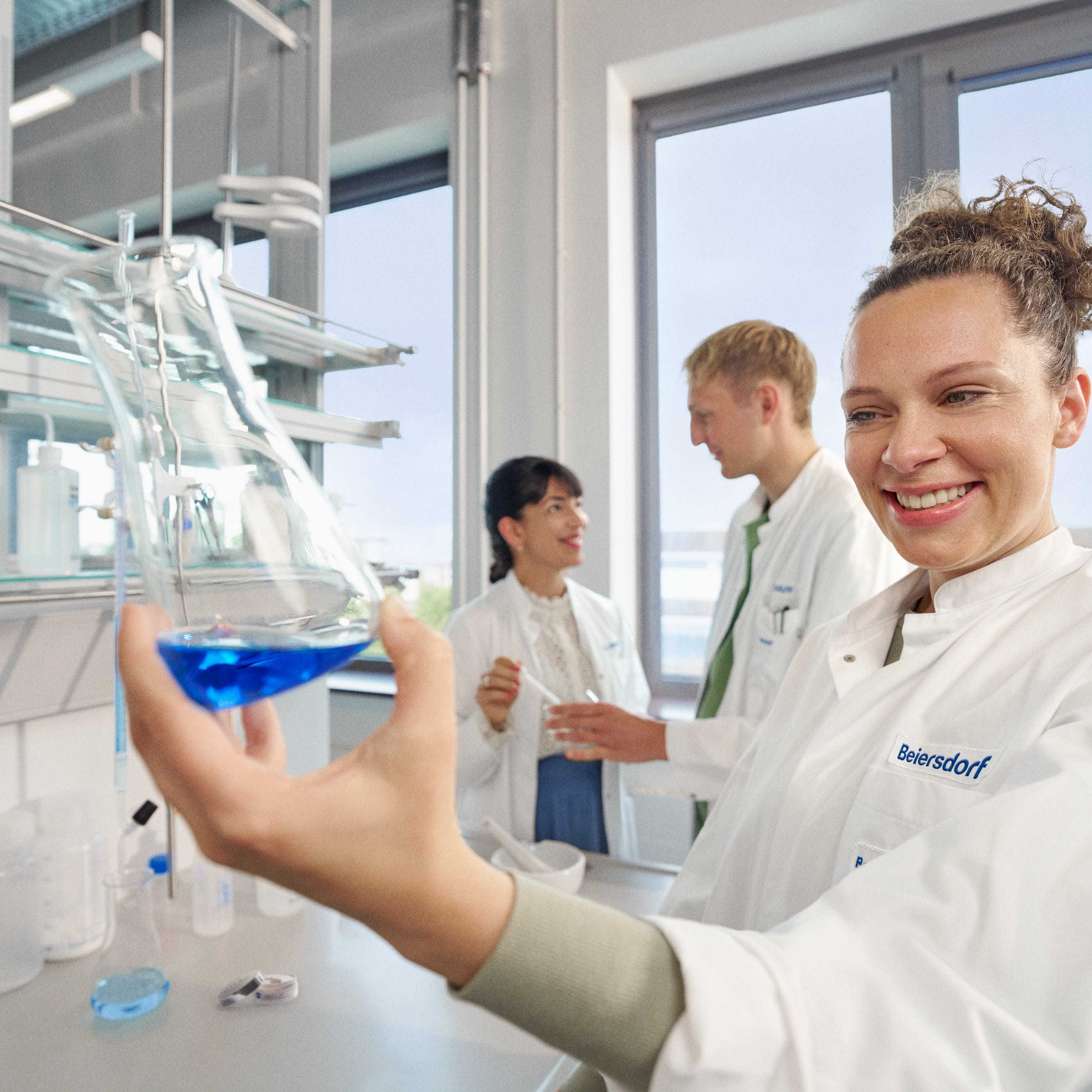 Beiersdorf researchers collaborating in a laboratory, driving innovation and the development of skincare and consumer care solutions.