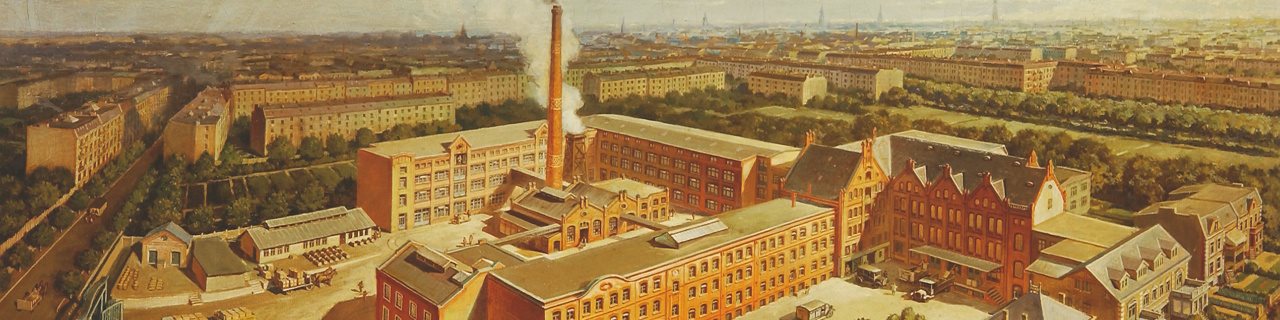 Illustrated aerial view of a historic industrial complex with red-brick factory buildings, a tall chimney and surrounding residential streets.