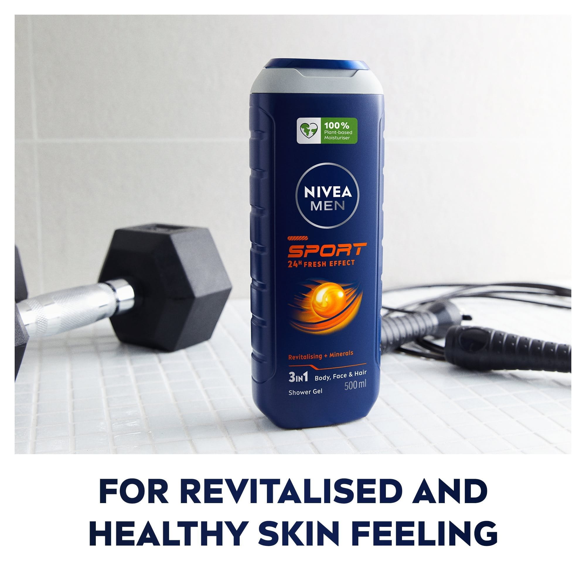 NIVEA MEN Sport 3-in-1 shower gel bottle standing on a tiled surface, with gym equipment in the background, highlighting its sporty and revitalising theme.