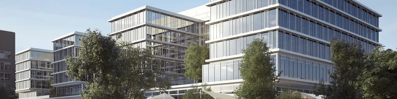 Modern multi-story office buildings with large glass façades and trees in the foreground, forming a contemporary corporate campus.