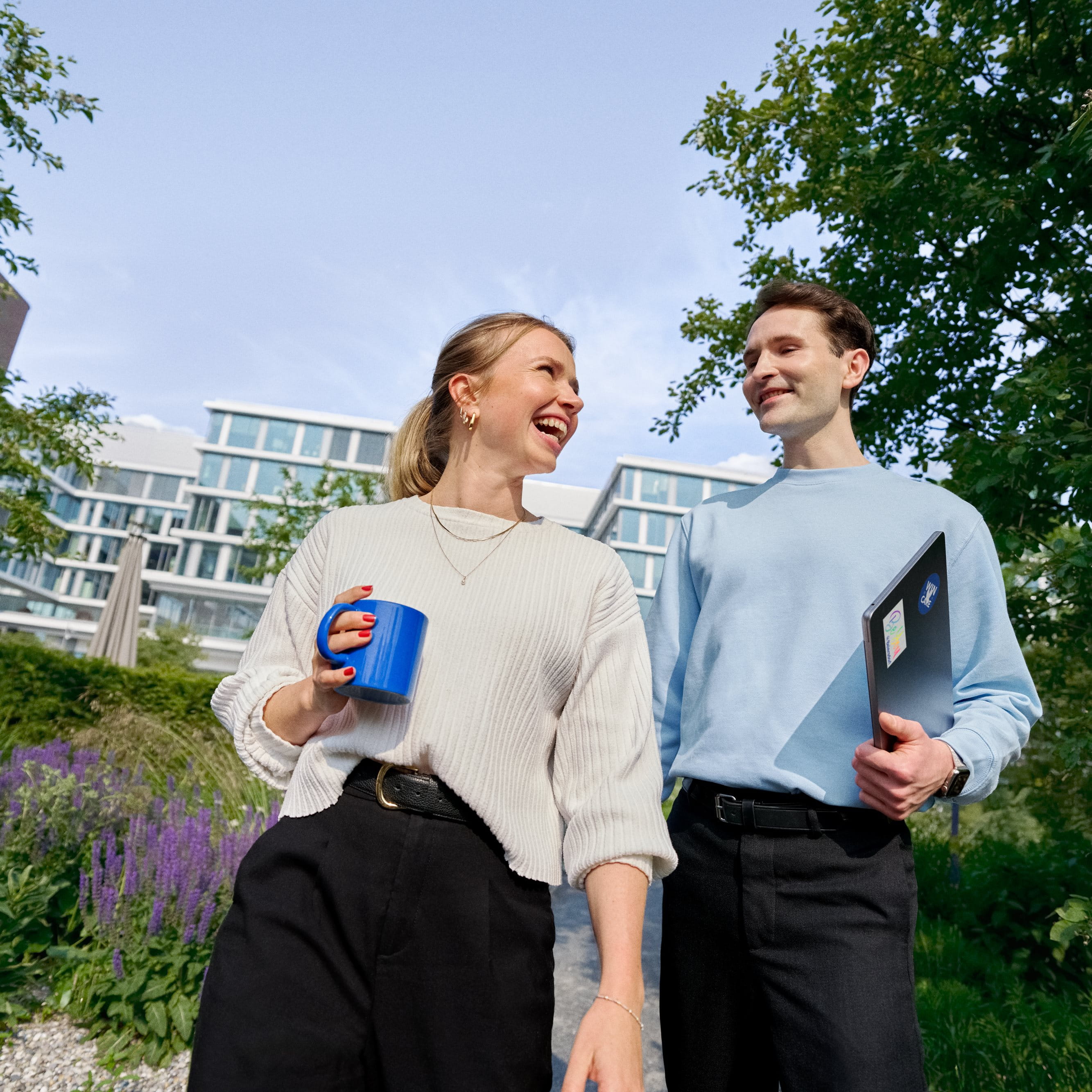 Beiersdorf employees connecting during a walk through the company campus, highlighting collaboration, workplace culture and flexible ways of working.