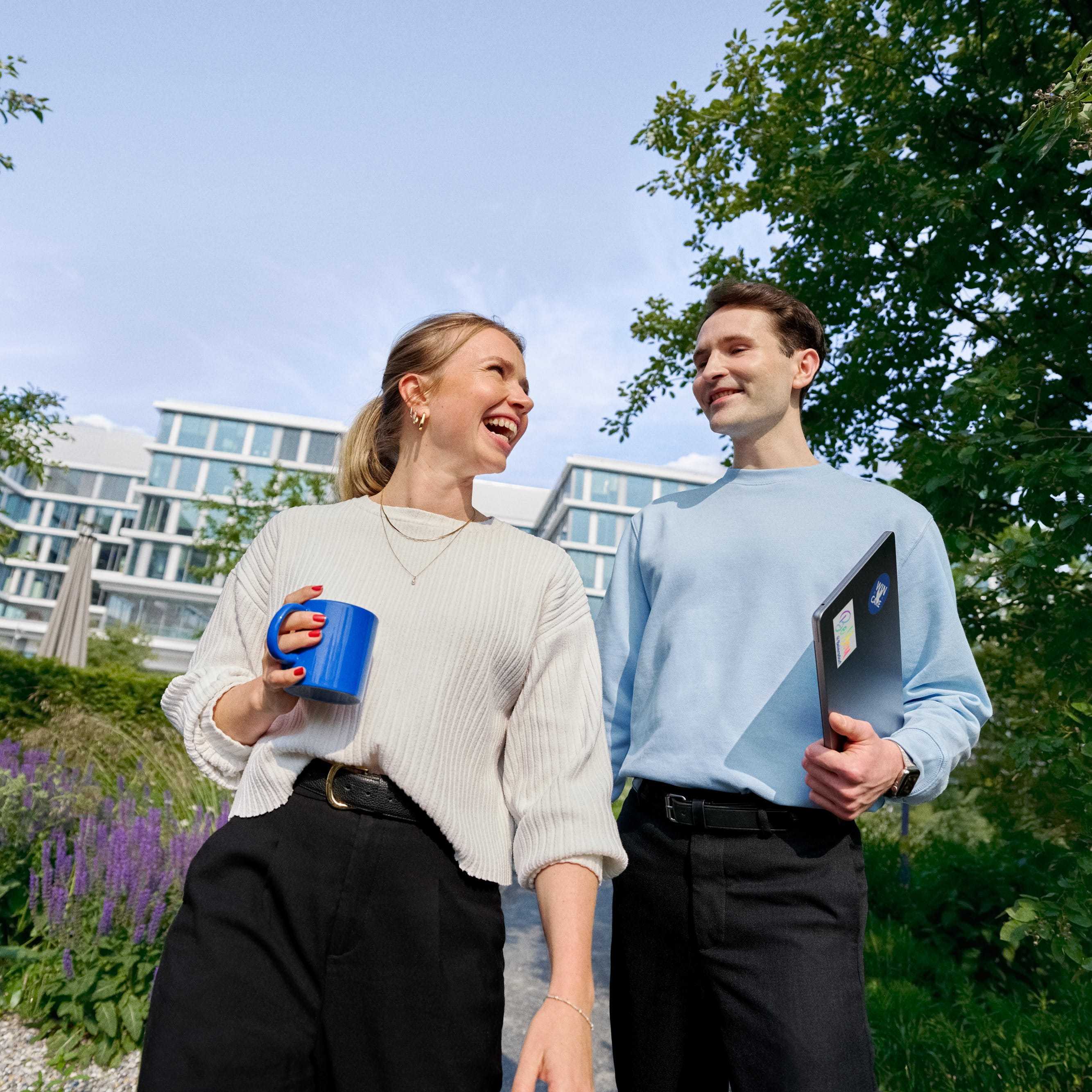 Beiersdorf employees connecting during a walk through the company campus, highlighting collaboration, workplace culture and flexible ways of working.