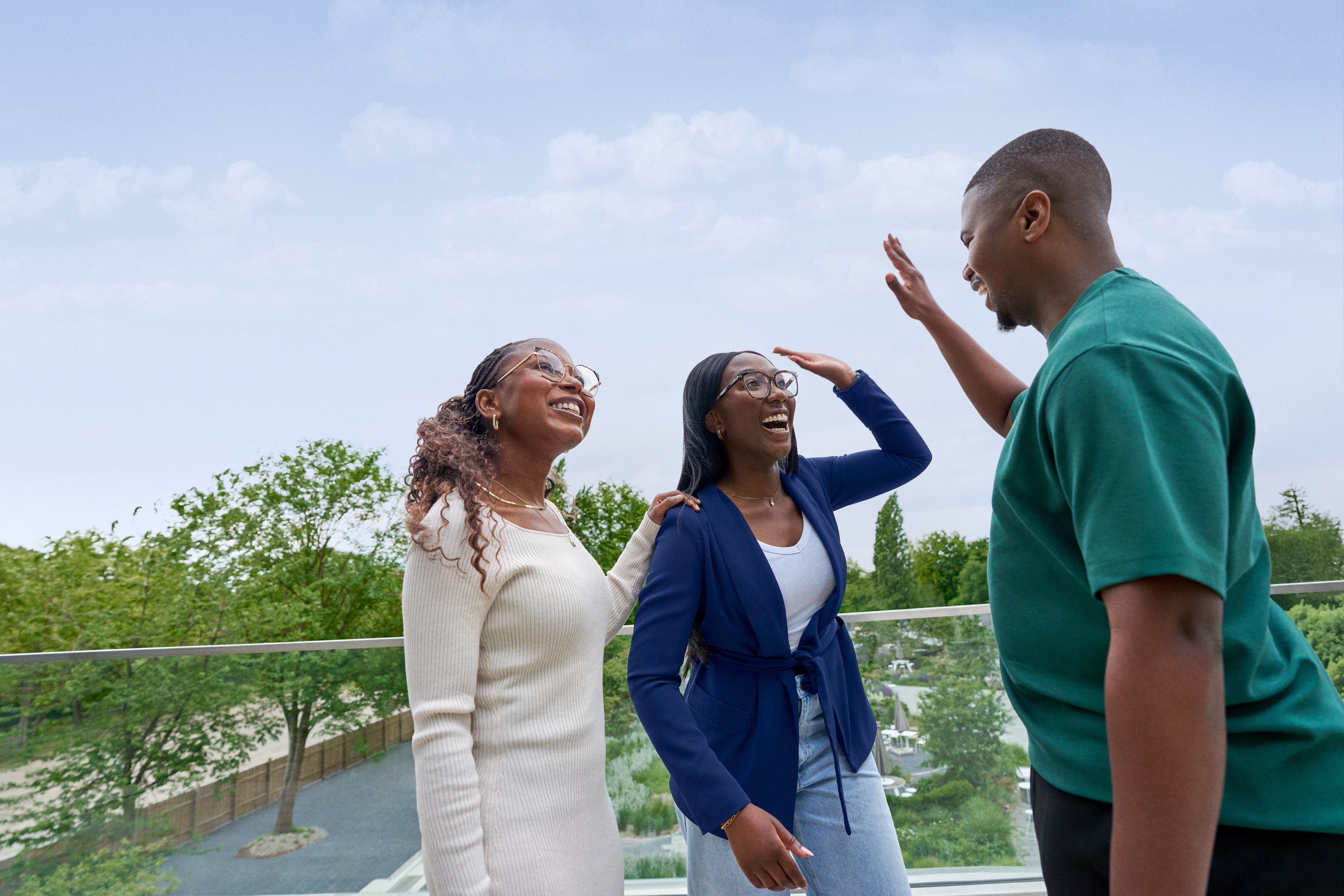 Beiersdorf employees celebrating a successful collaboration with a high five, representing teamwork and an inclusive work environment.