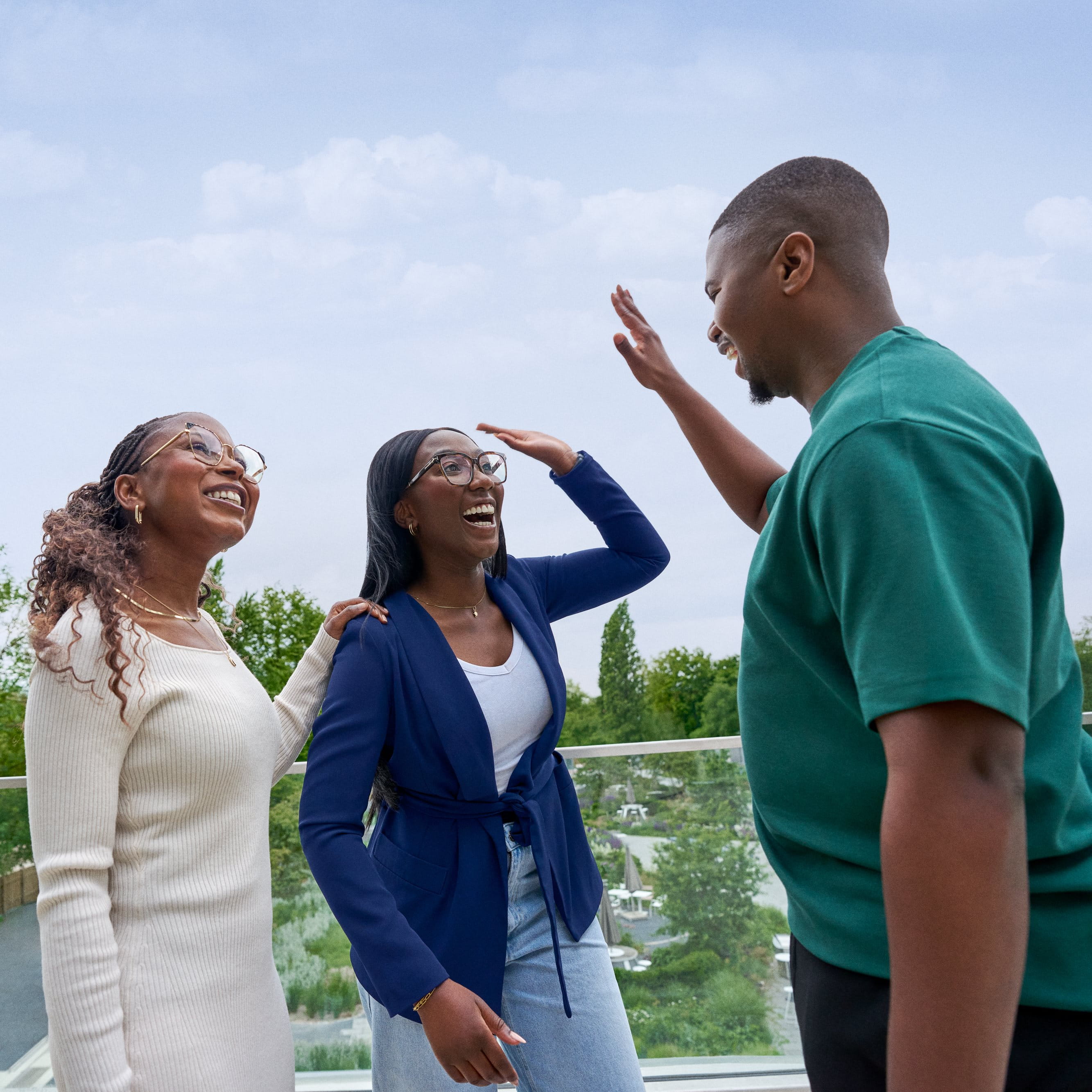 Beiersdorf employees celebrating a successful collaboration with a high five, representing teamwork and an inclusive work environment.