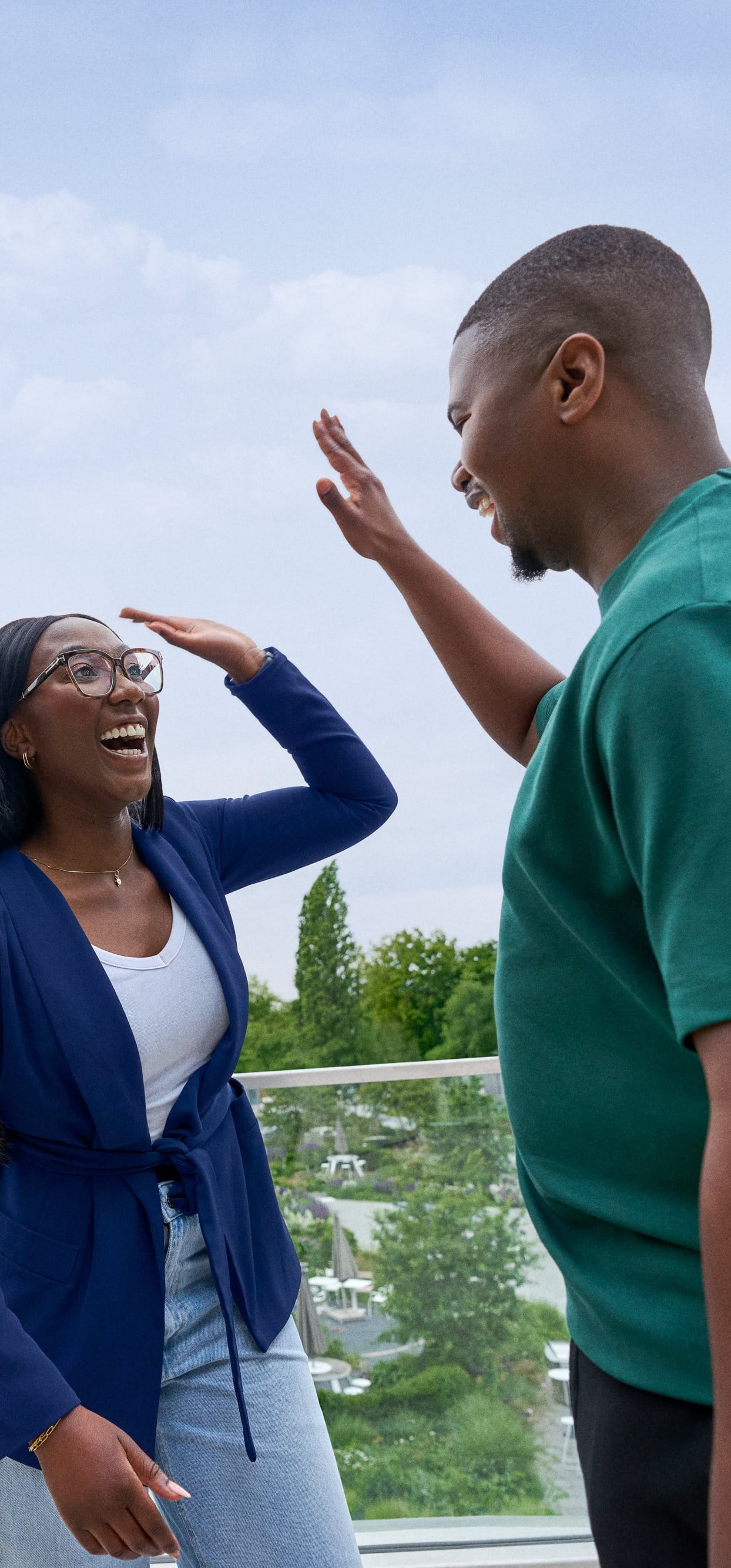 Beiersdorf employees celebrating a successful collaboration with a high five, representing teamwork and an inclusive work environment.