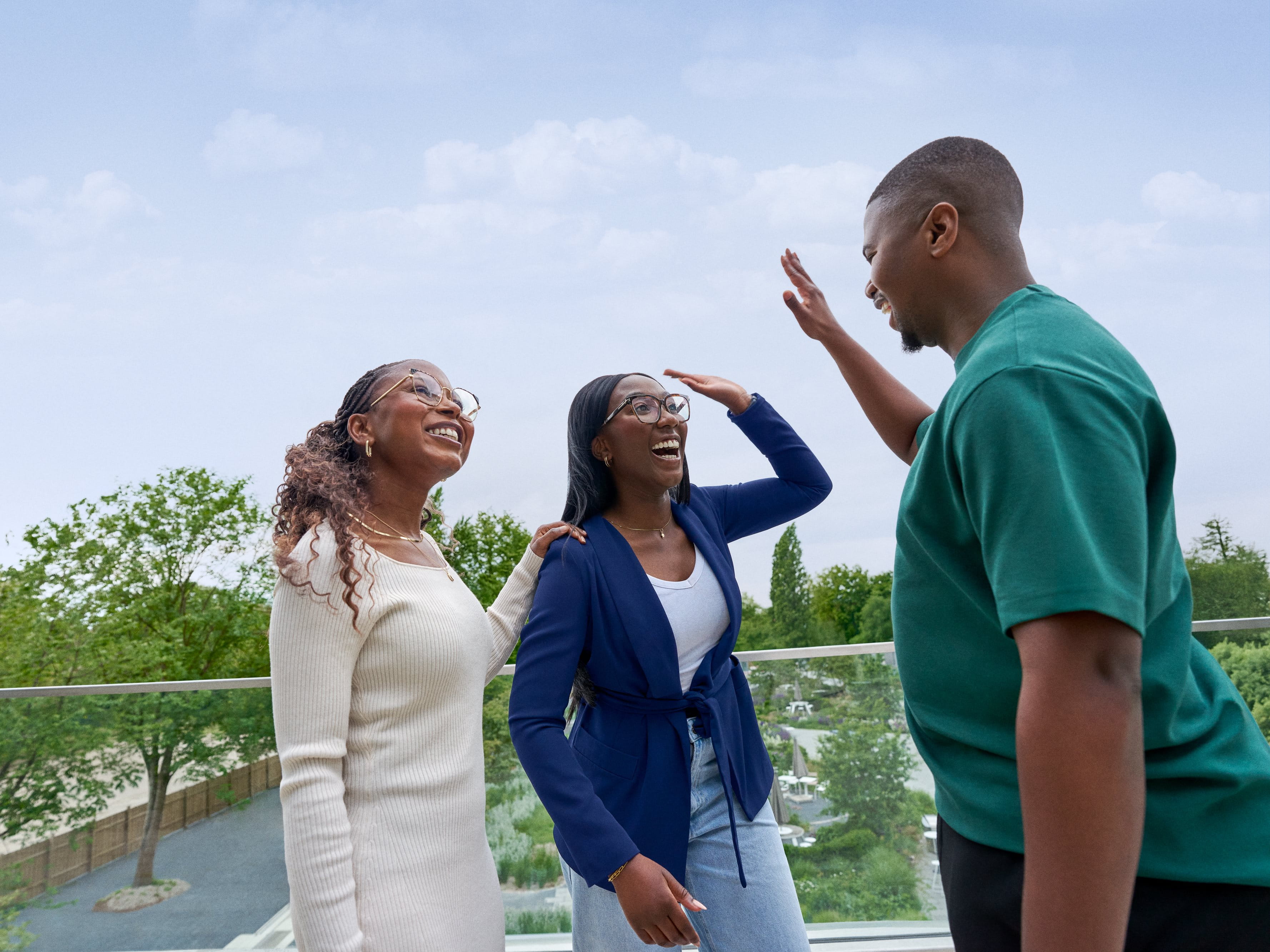Beiersdorf employees celebrating a successful collaboration with a high five, representing teamwork and an inclusive work environment.