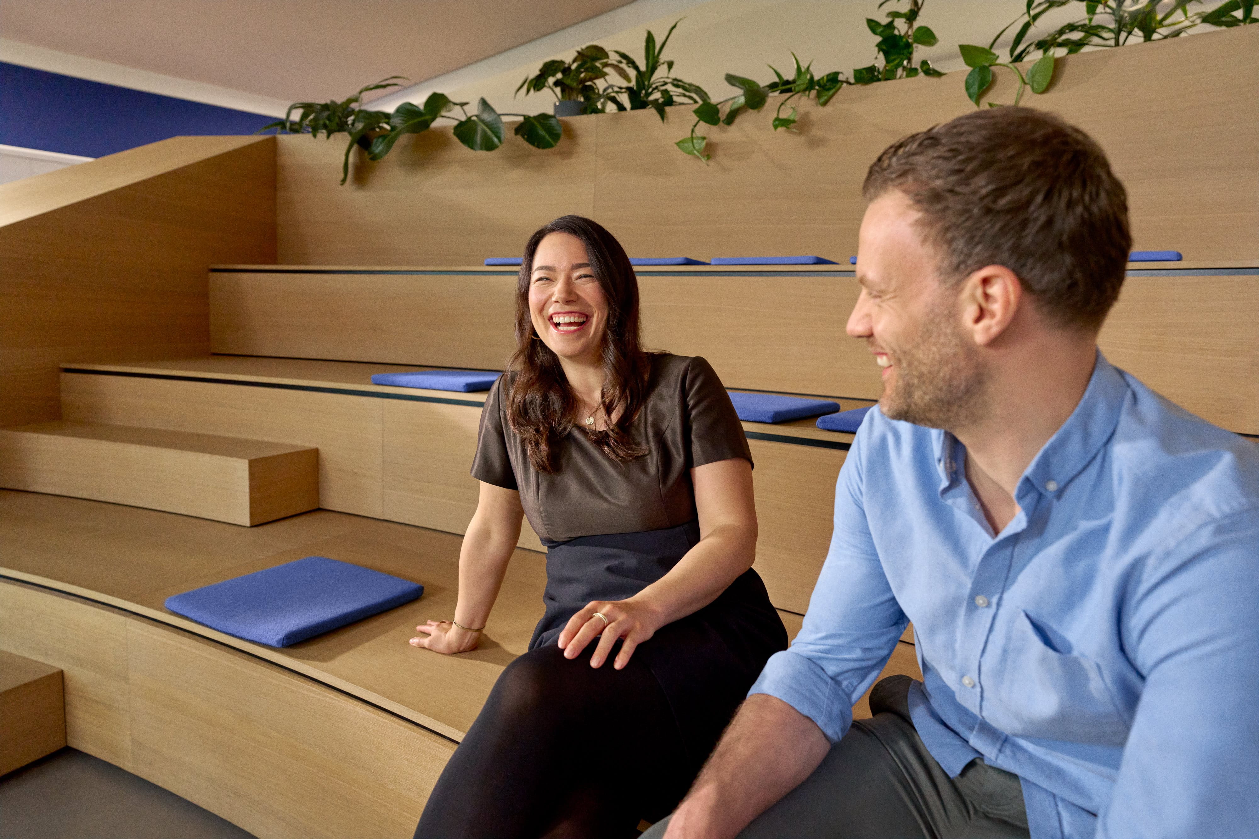 Beiersdorf employees engaging in conversation within a collaborative workspace, reflecting an open culture, teamwork and employee experience.