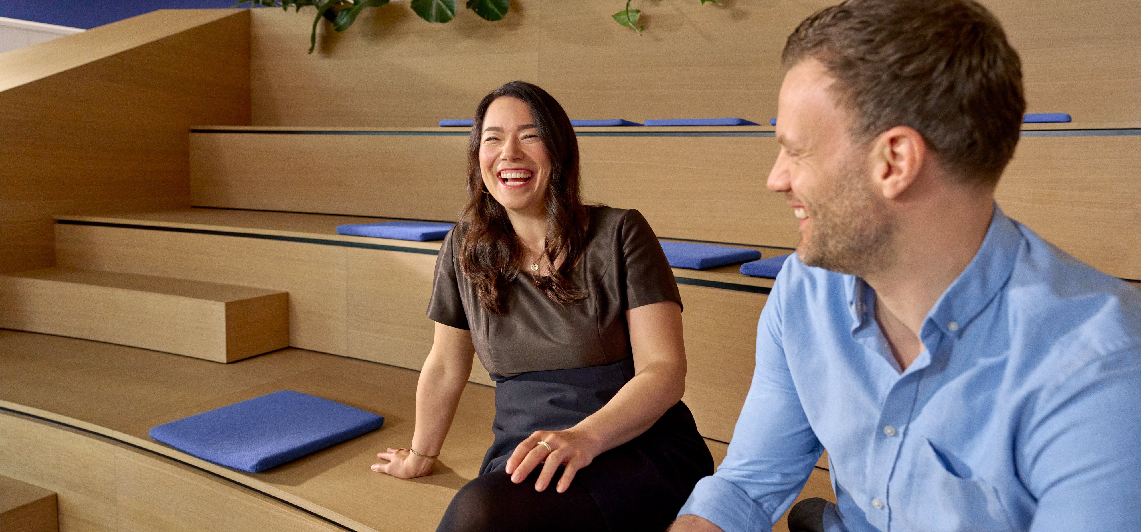 Beiersdorf employees engaging in conversation within a collaborative workspace, reflecting an open culture, teamwork and employee experience.