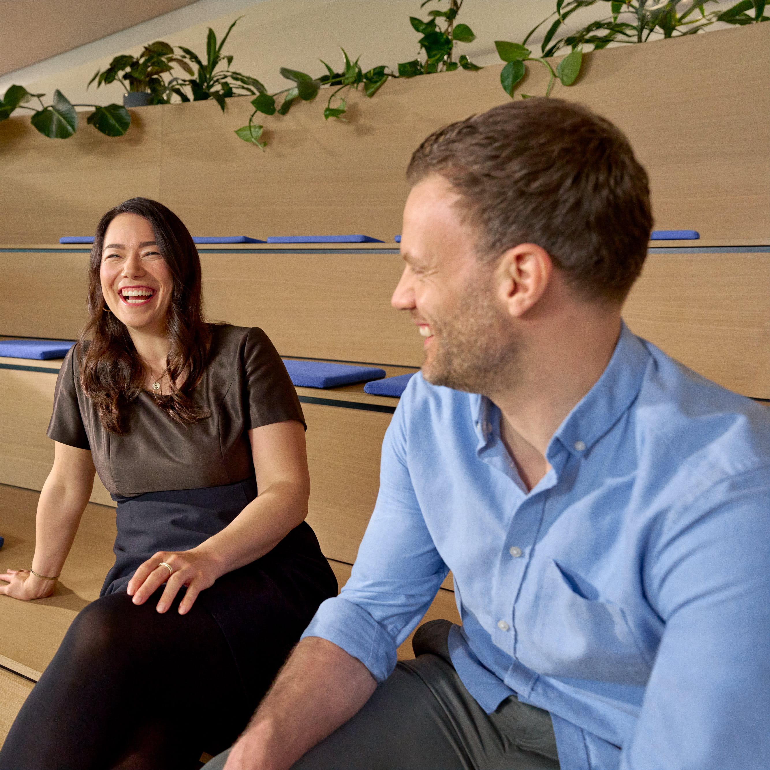 Beiersdorf employees engaging in conversation within a collaborative workspace, reflecting an open culture, teamwork and employee experience.