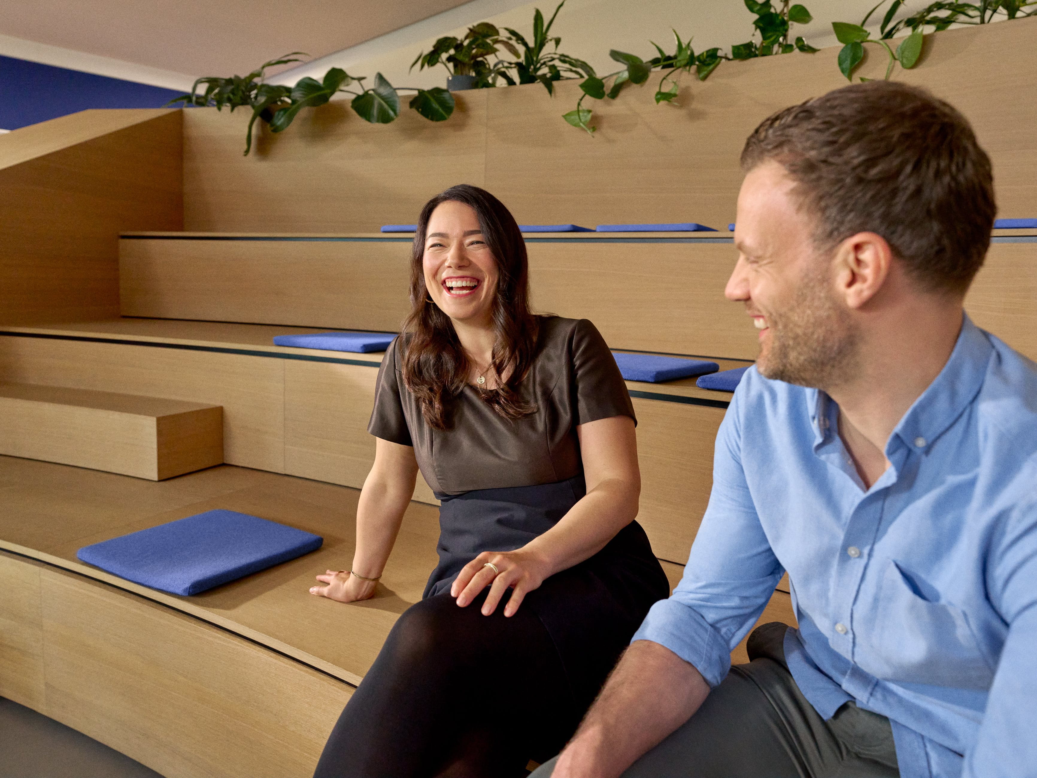 Beiersdorf employees engaging in conversation within a collaborative workspace, reflecting an open culture, teamwork and employee experience.