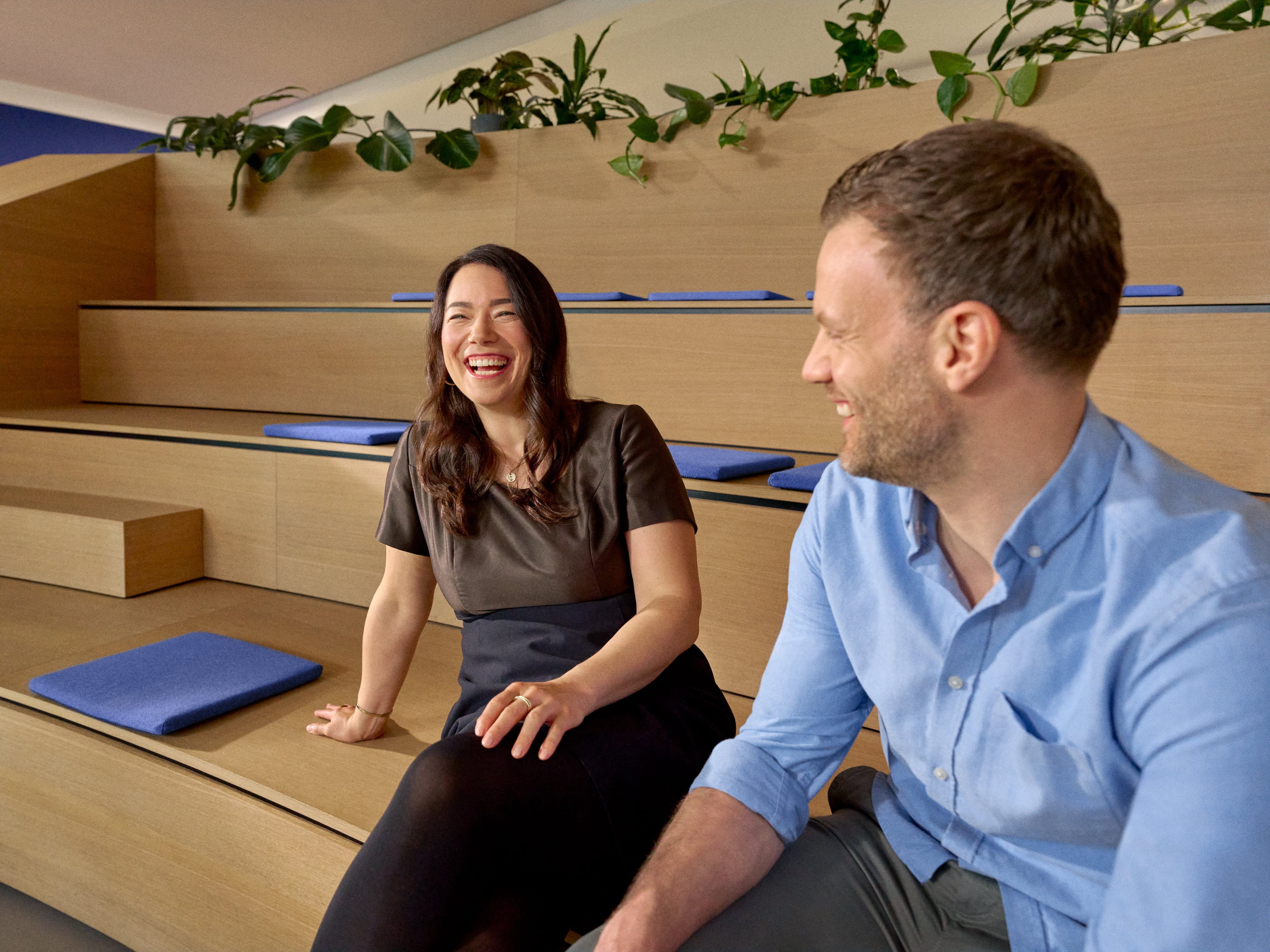 Beiersdorf employees engaging in conversation within a collaborative workspace, reflecting an open culture, teamwork and employee experience.