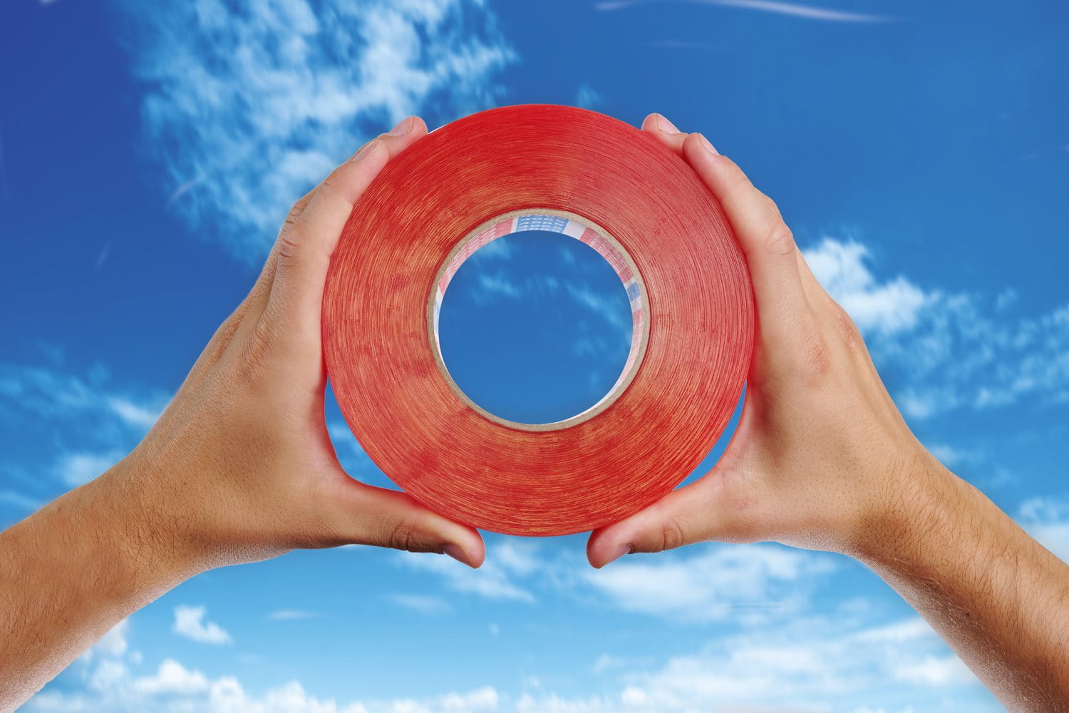 Row of cosmetic foundation or skincare bottles in varying shades, arranged side by side against a neutral background to showcase a broad range of skin tones.