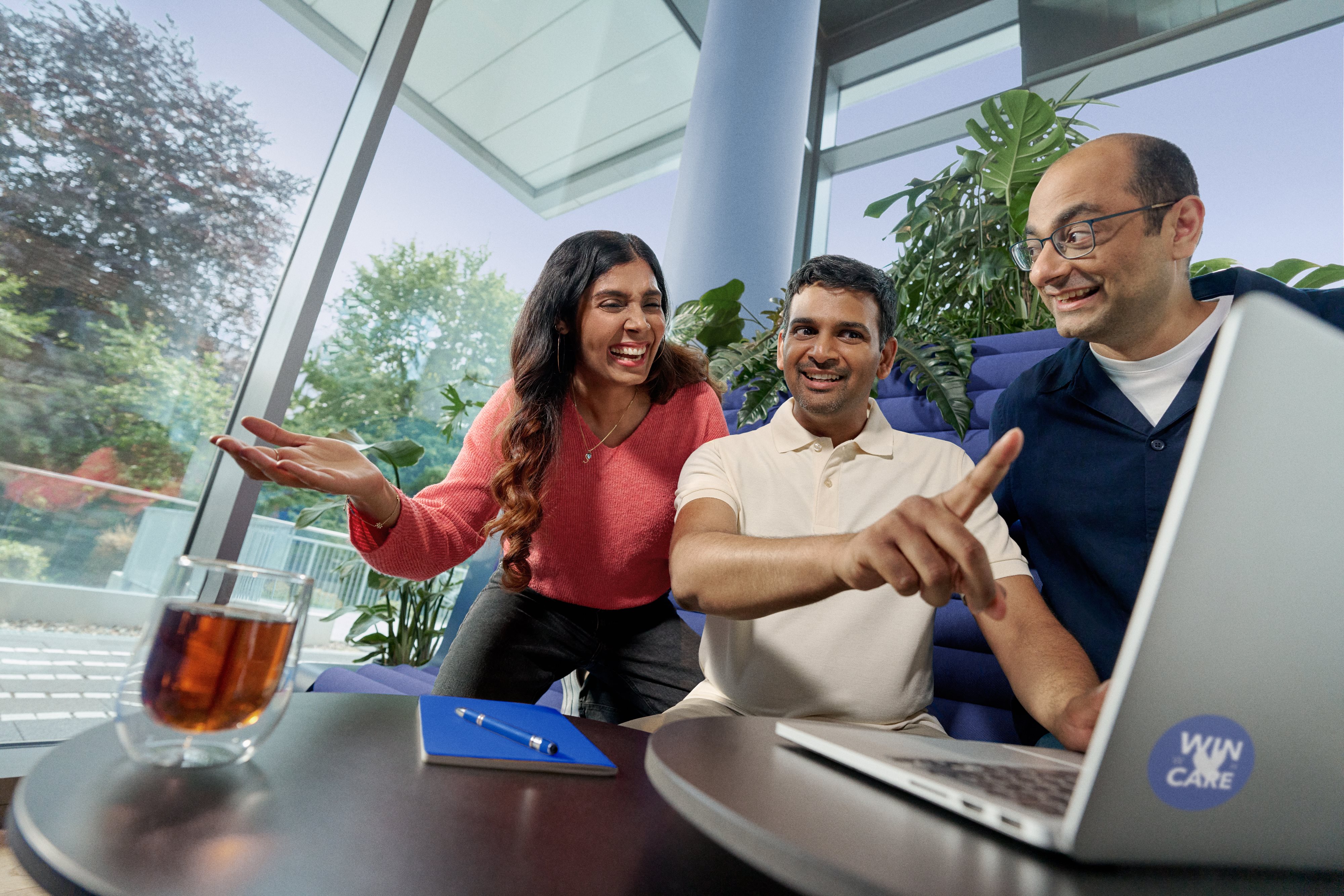 Beiersdorf employees collaborating on a project in a modern office, demonstrating teamwork and an inclusive workplace culture