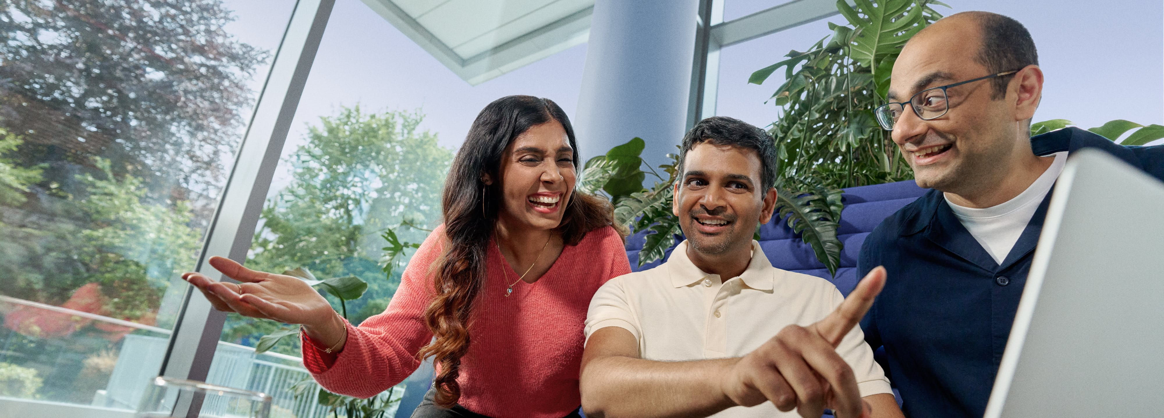 Beiersdorf employees collaborating on a project in a modern office, demonstrating teamwork and an inclusive workplace culture