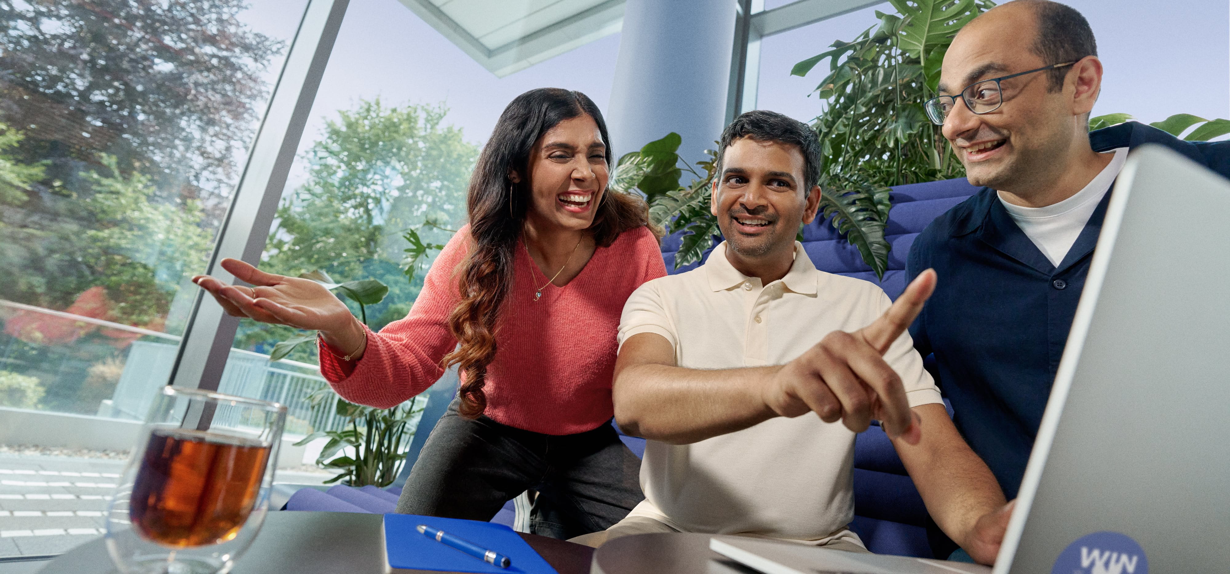 Beiersdorf employees collaborating on a project in a modern office, demonstrating teamwork and an inclusive workplace culture