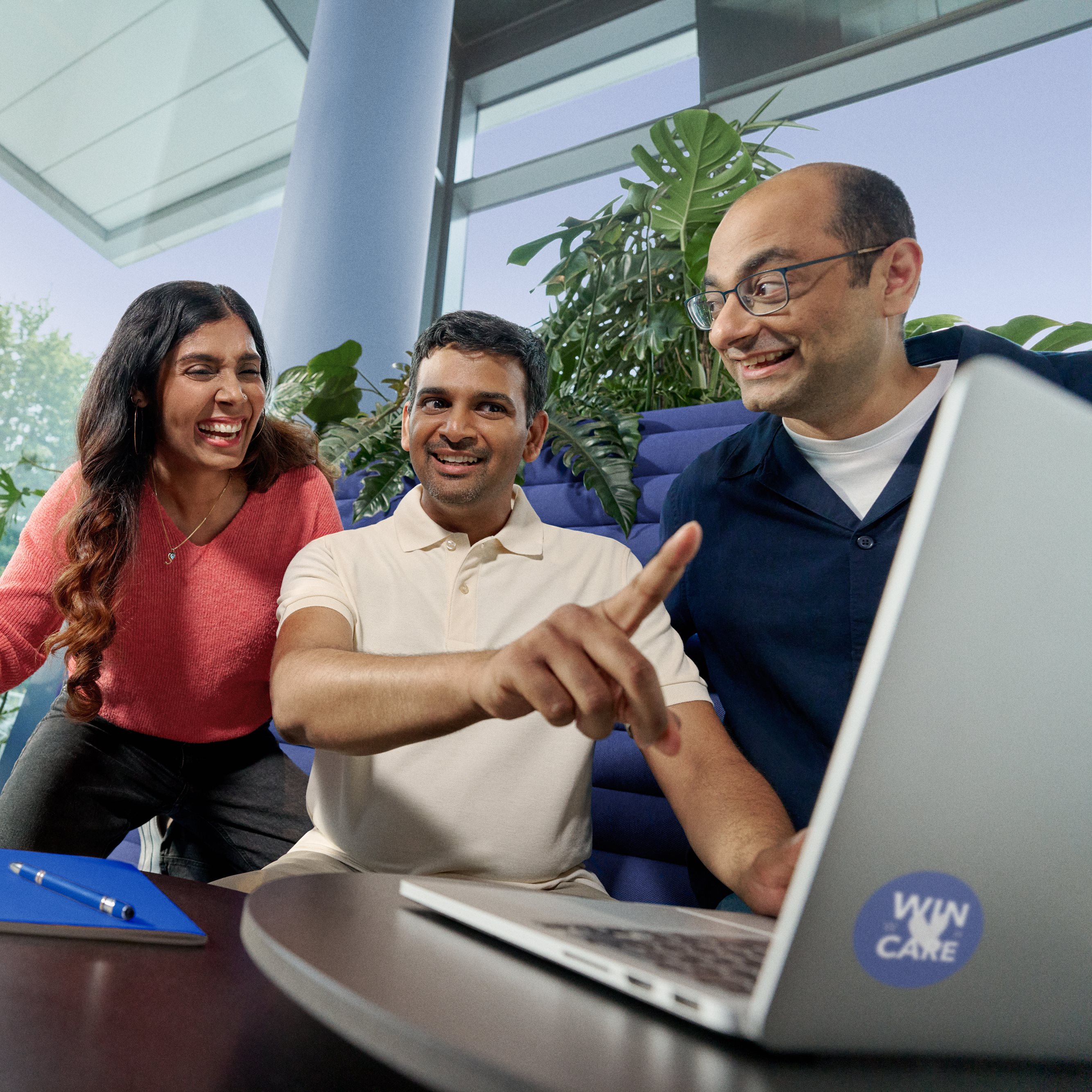 Beiersdorf employees collaborating on a project in a modern office, demonstrating teamwork and an inclusive workplace culture