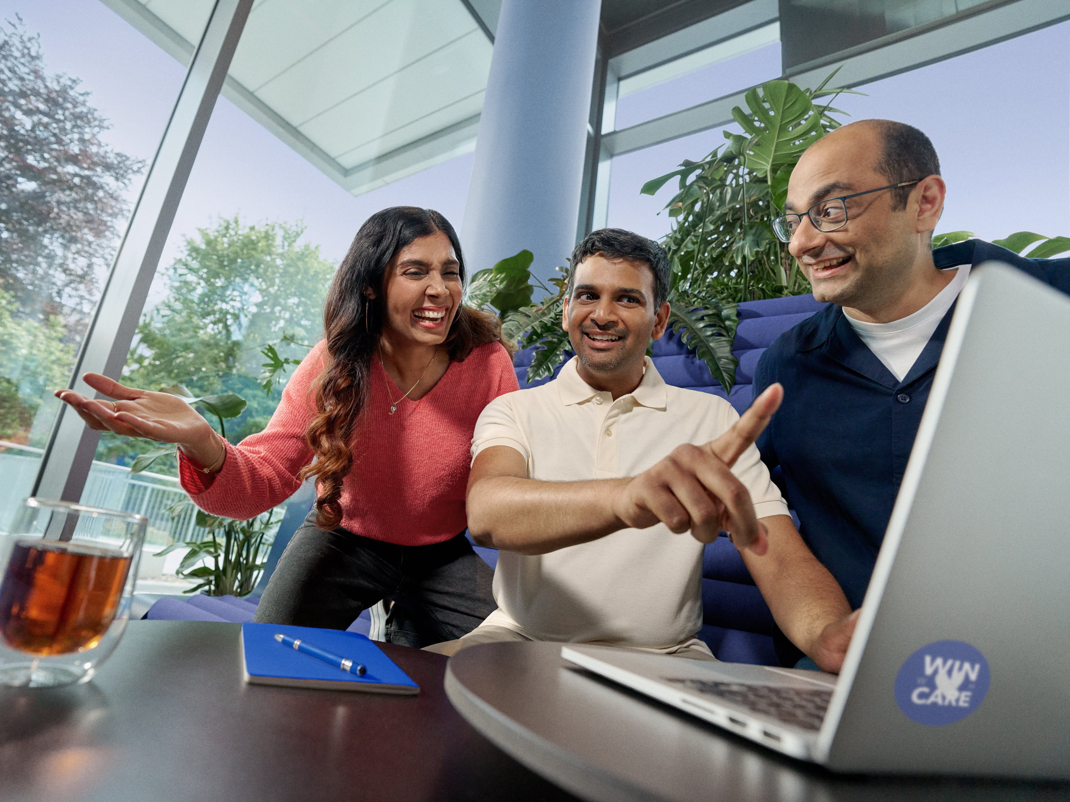 Beiersdorf employees collaborating on a project in a modern office, demonstrating teamwork and an inclusive workplace culture